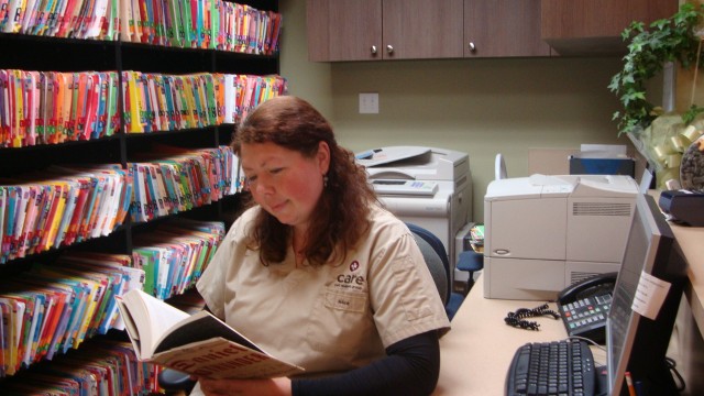 Alice reads a BC book in a break between caring for patients at the pet hospital.